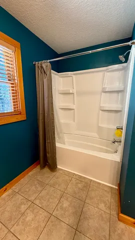 a wooden bench sitting in the middle of a yard