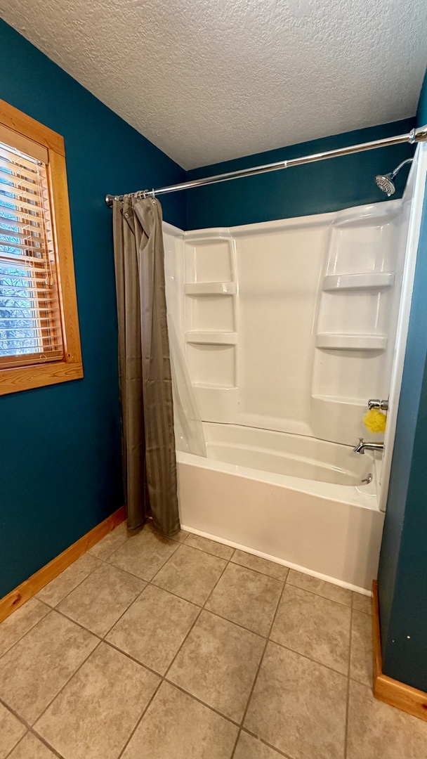 9120 Spring Valley Road Fulton, IL 61252 - Photo 40 of 59 a bathroom with a bathtub and a shower
