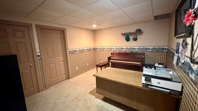 an aerial view of a couch with table and chairs