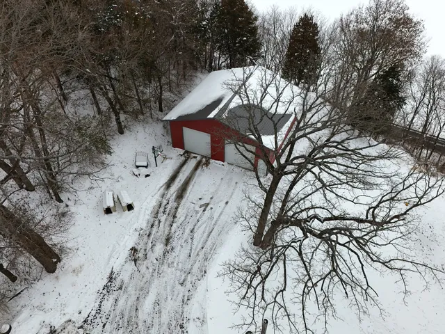 a view of a house with snow on the road
