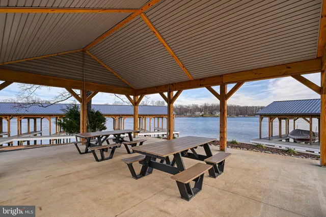 an outdoor sitting area with couch and wooden roof