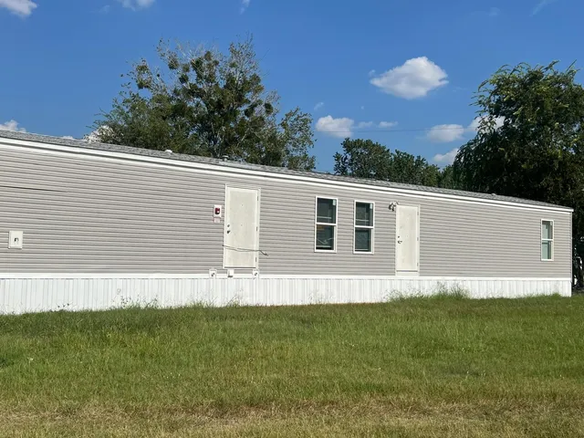 a side view of a house with a yard