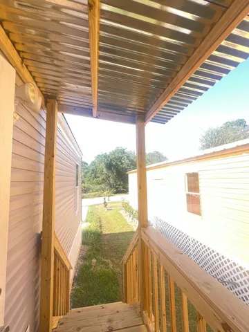 a view of a balcony with yard