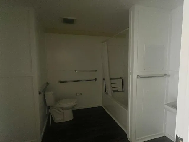 a bathroom with a toilet and a shower