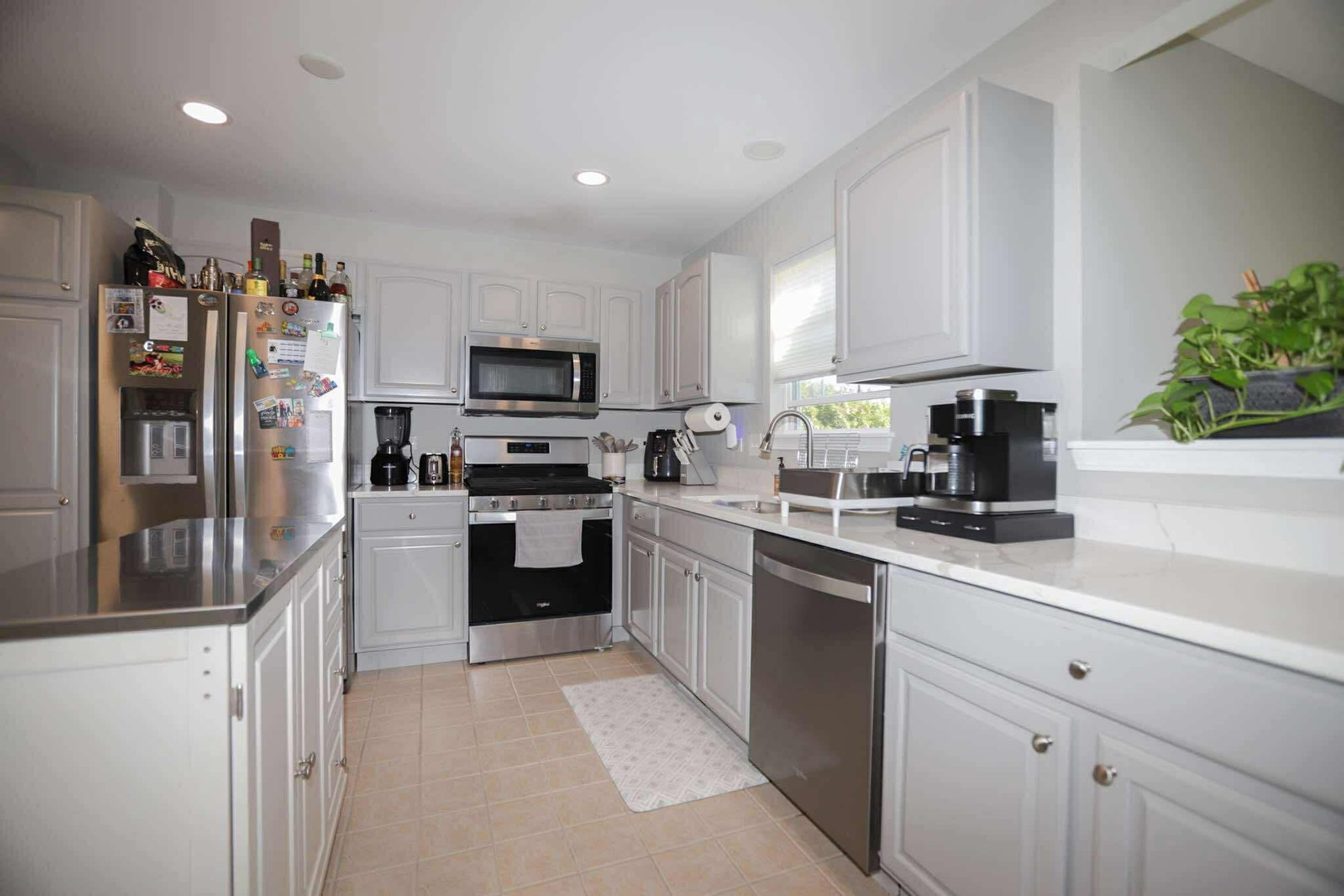 1117 Draper Road, Unit 1117 McHenry, IL 60050 - Photo 3 of 16 a kitchen with granite countertop a refrigerator and a sink