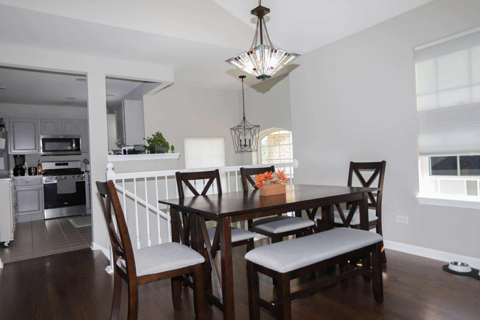 1117 Draper Road, Unit 1117 McHenry, IL 60050 - Photo 4 of 16 a view of a dining room with furniture a chandelier and wooden floor