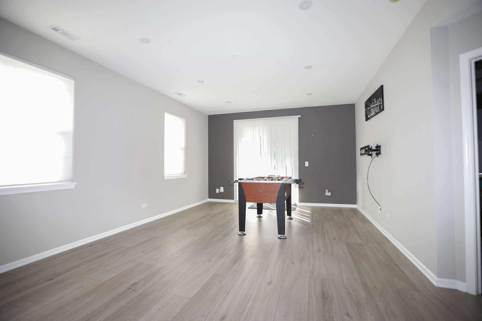 1117 Draper Road, Unit 1117 McHenry, IL 60050 - Photo 6 of 16 an empty room with wooden floor and windows