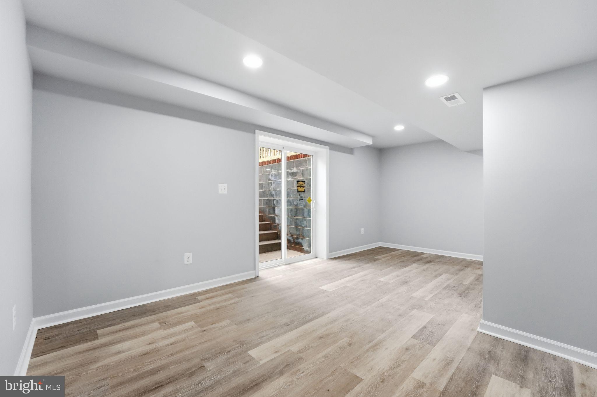 984 Oak Park Road Madison, VA 22727 - Photo 14 of 20 an empty room with wooden floor and windows