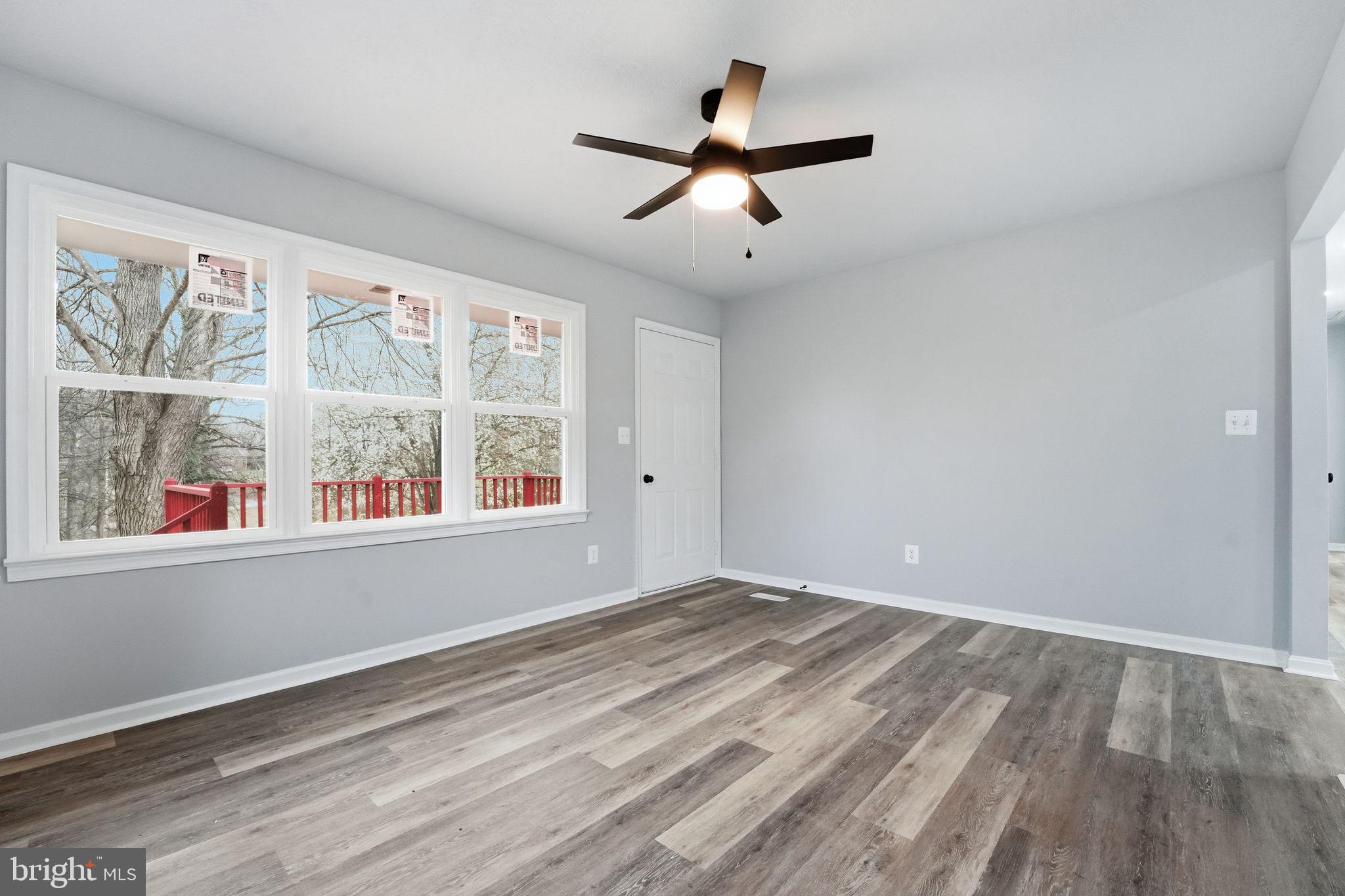 984 Oak Park Road Madison, VA 22727 - Photo 5 of 20 a view of empty room with wooden floor and fan