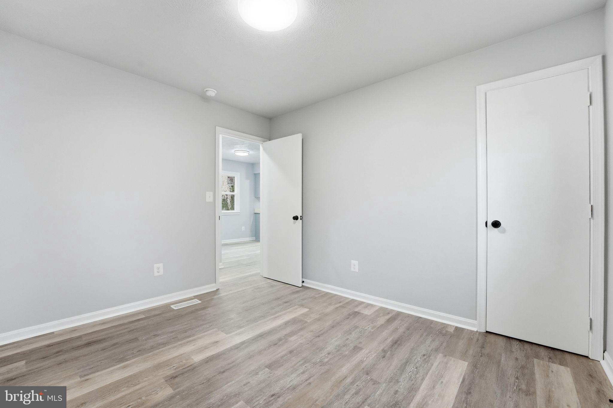 984 Oak Park Road Madison, VA 22727 - Photo 7 of 20 a view of an empty room with wooden floor