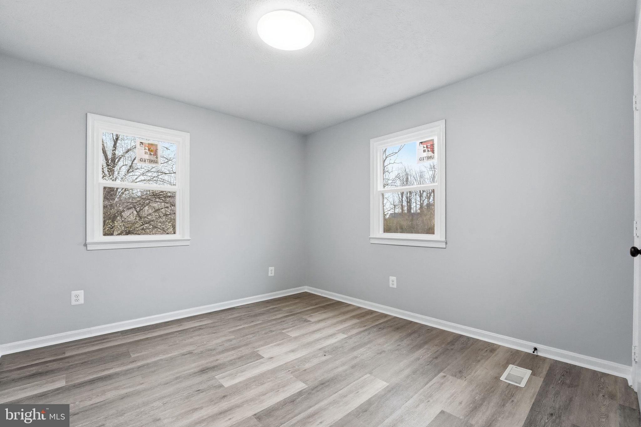 984 Oak Park Road Madison, VA 22727 - Photo 9 of 20 a view of empty room with window and wooden floor