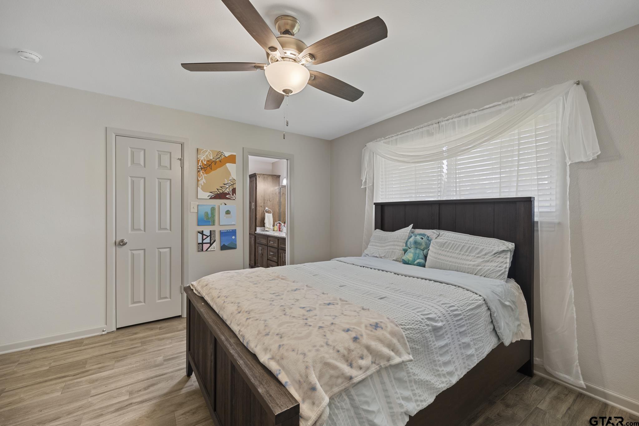 2201 Ridgley Tyler, TX 75703 - Photo 26 of 42 a bedroom with a bed and a chandelier