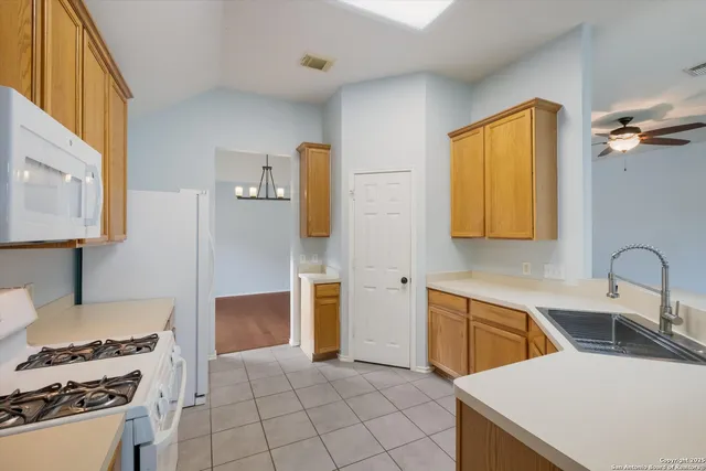a kitchen that has a sink and a stove