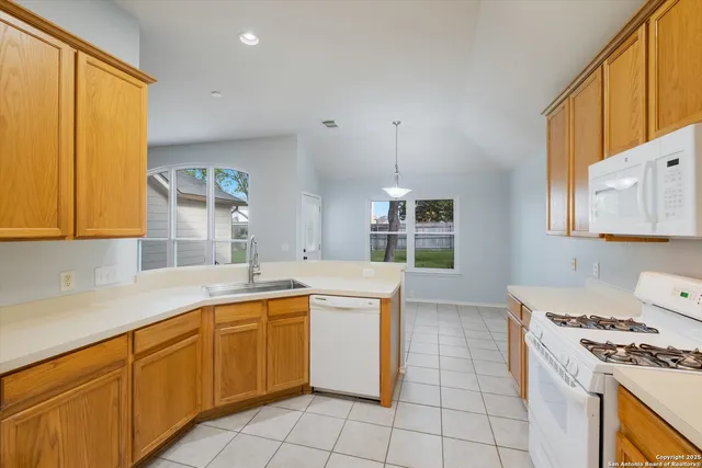 a kitchen with a sink stove and cabinets
