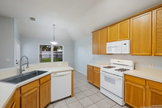 a kitchen that has a sink and a stove