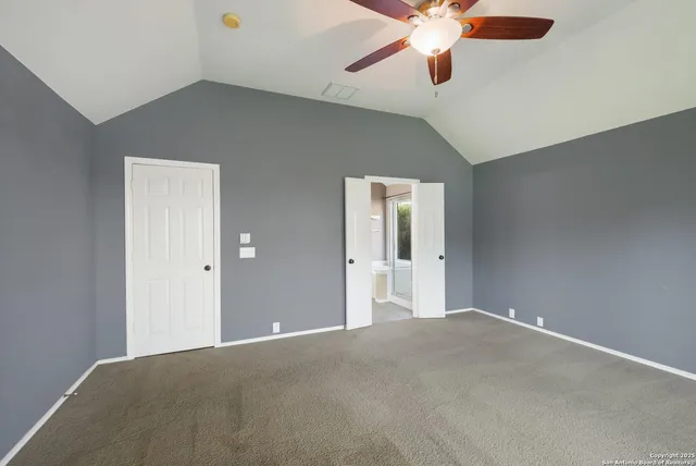 a view of a big room with chandelier fan