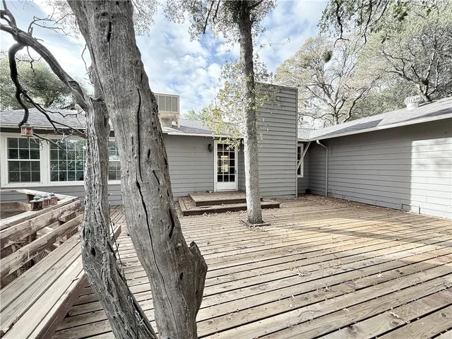 a view of a house with a yard and tree