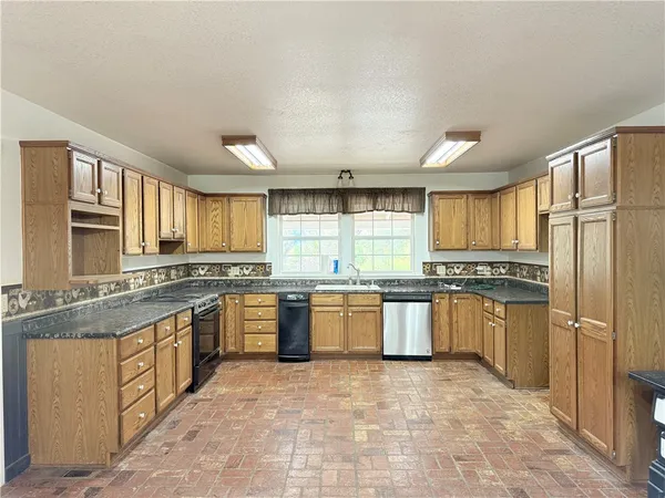 a view of a livingroom with a dishwasher and a refrigerator