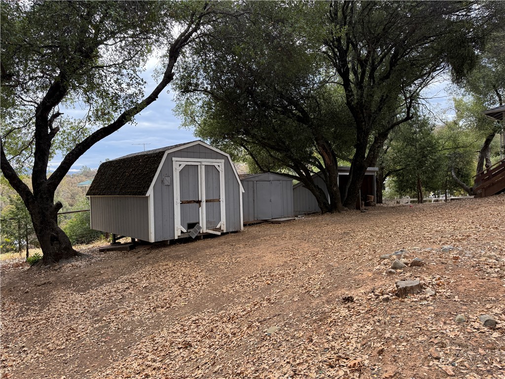 5264 Davis Road Midpines, CA 95345 - Photo 46 of 48 a big house with large trees and wooden fence