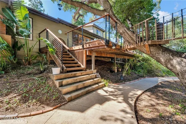 a large kitchen with stainless steel appliances granite countertop a lot of counter space and wooden floor