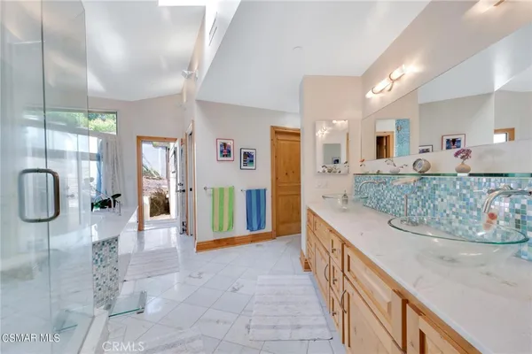 a large kitchen with stainless steel appliances granite countertop a refrigerator and a stove top oven