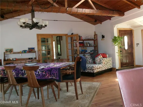 a bedroom with furniture and a large window