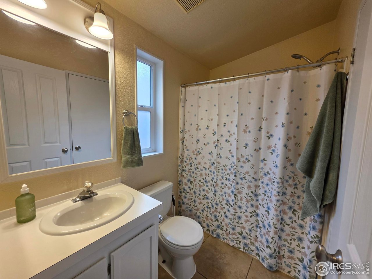 3272 North Rim, Unit 136 Longmont, CO 80504 - Photo 27 of 38 a bathroom with a sink toilet and shower