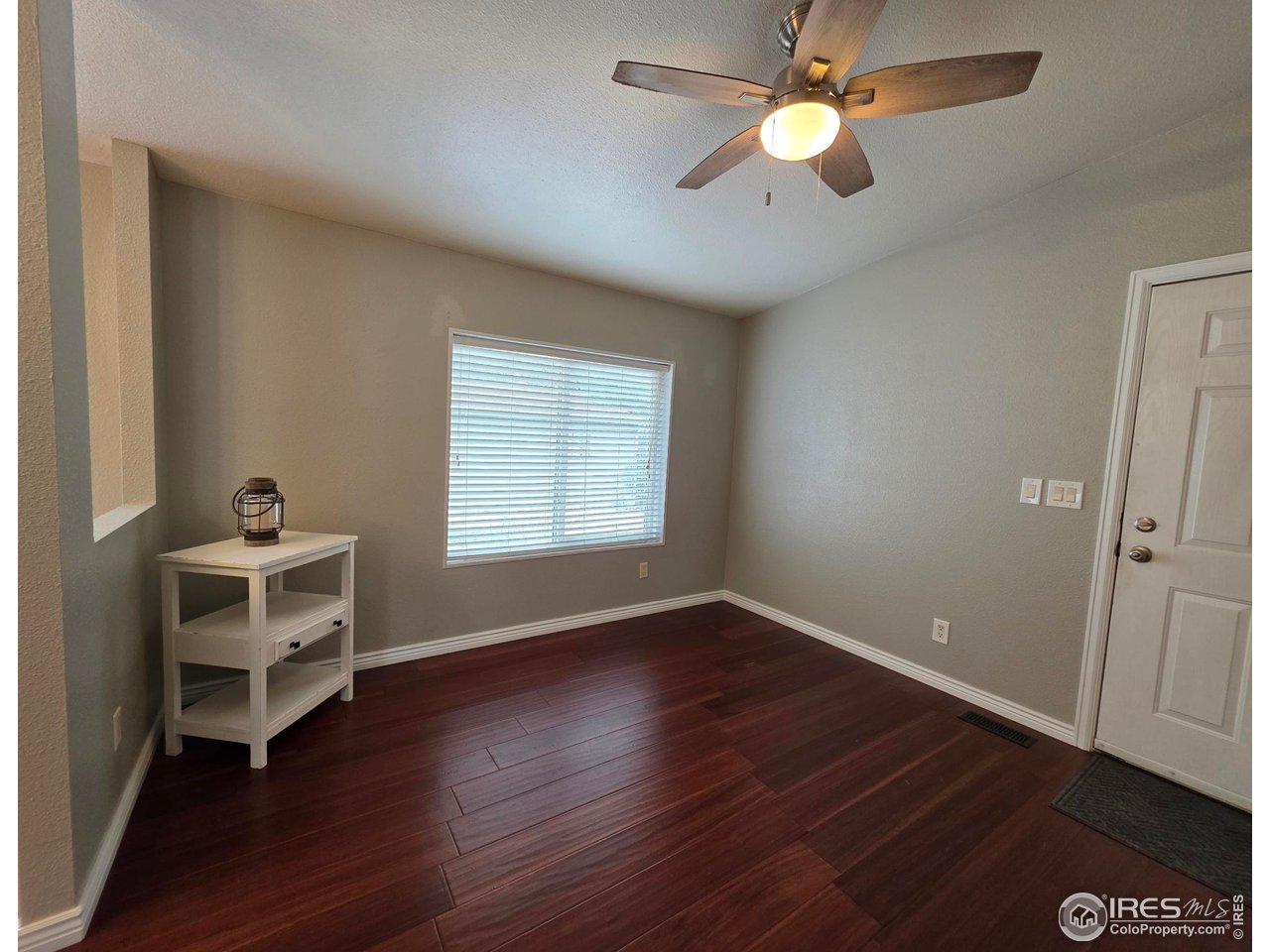 3272 North Rim, Unit 136 Longmont, CO 80504 - Photo 9 of 38 wooden floor in an empty room with a window