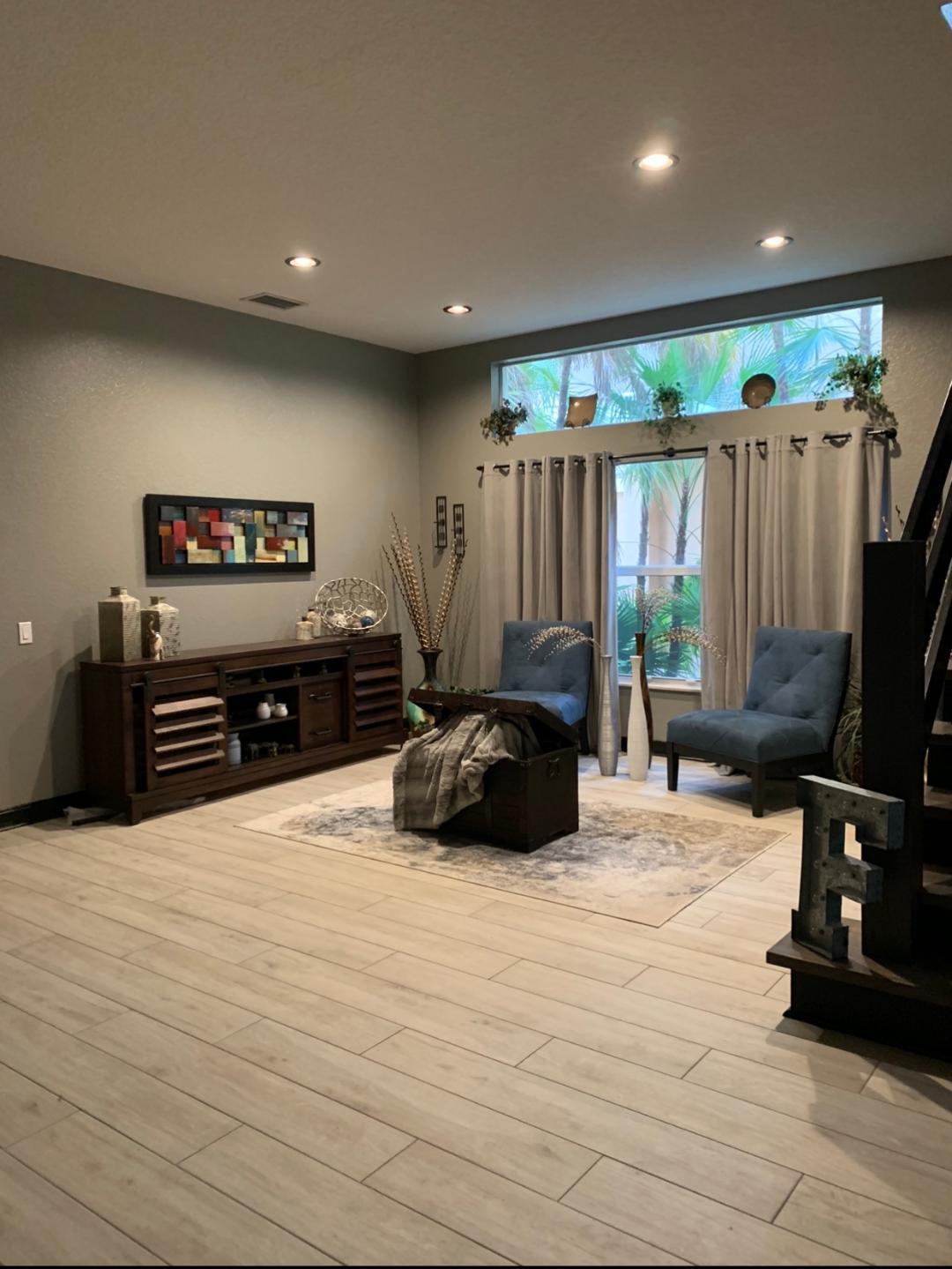 7907 Emerald Winds Circle Boynton Beach, FL 33473 - Photo 3 of 39 a bed room with furniture and a flat screen tv