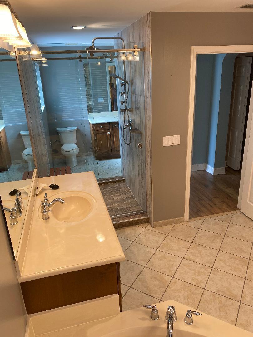 7907 Emerald Winds Circle Boynton Beach, FL 33473 - Photo 33 of 39 a bathroom with a bathtub and shower