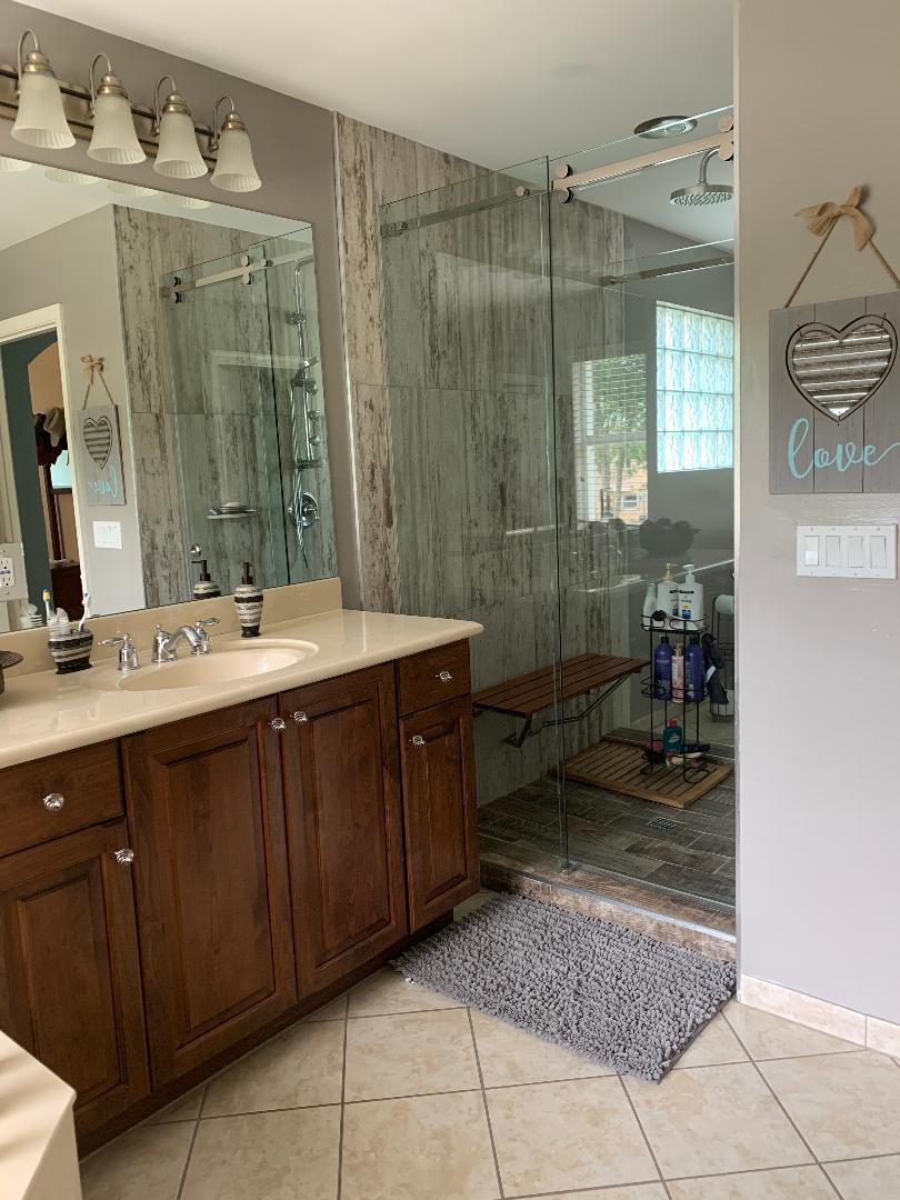 7907 Emerald Winds Circle Boynton Beach, FL 33473 - Photo 37 of 39 a bathroom with a double vanity sink and a mirror