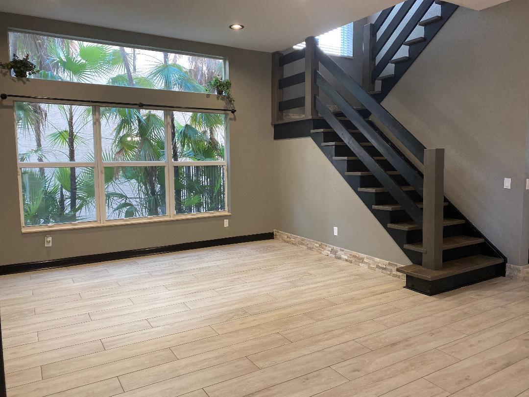 7907 Emerald Winds Circle Boynton Beach, FL 33473 - Photo 6 of 39 a view of an empty room with wooden floor and windows