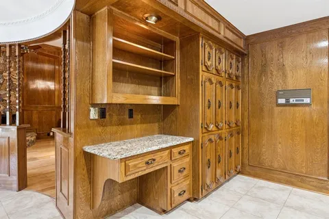 a bathroom with a granite countertop sink and mirror