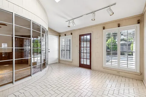 a view of an empty room with windows