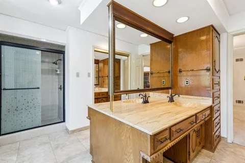 a bathroom with a sink a vanity a mirror and a bathtub