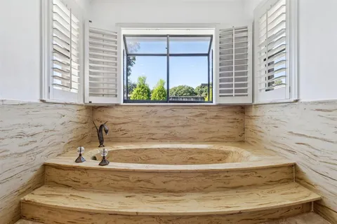 a view of kitchen with kitchen island a sink and a refrigerator