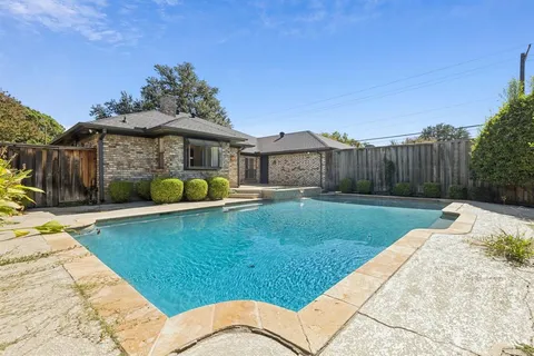 a view of a backyard with swimming pool