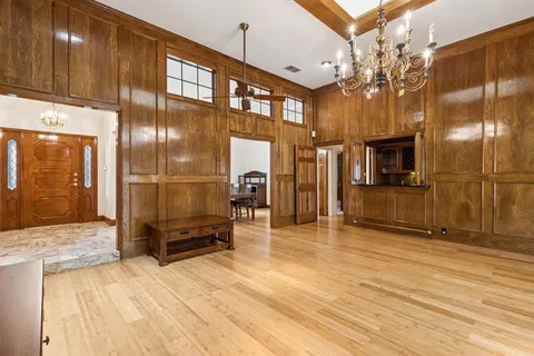 a view of a hallway with a livingroom with furniture