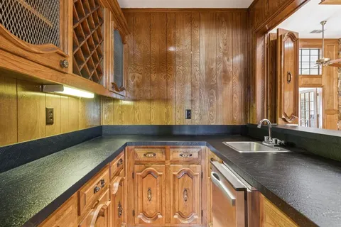 a view of a kitchen with granite countertop a sink and a granite counter tops