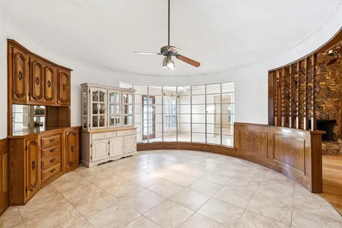 a large white kitchen with granite countertop a sink and cabinets