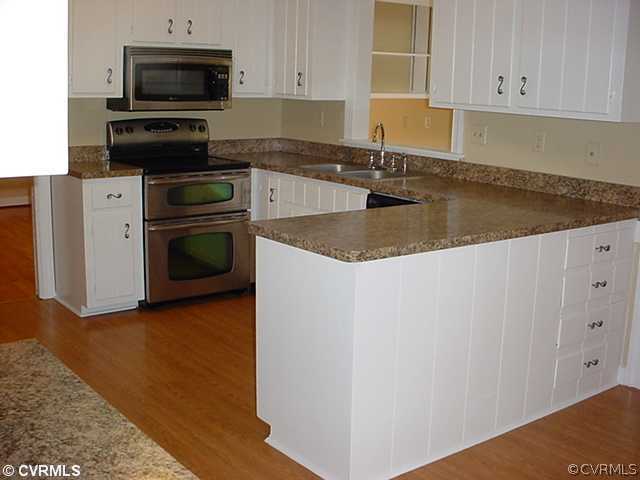 2518 Tanglebrook Road Midlothian, VA 23112 - Photo 6 of 12 a kitchen with granite countertop a sink a stove and microwave
