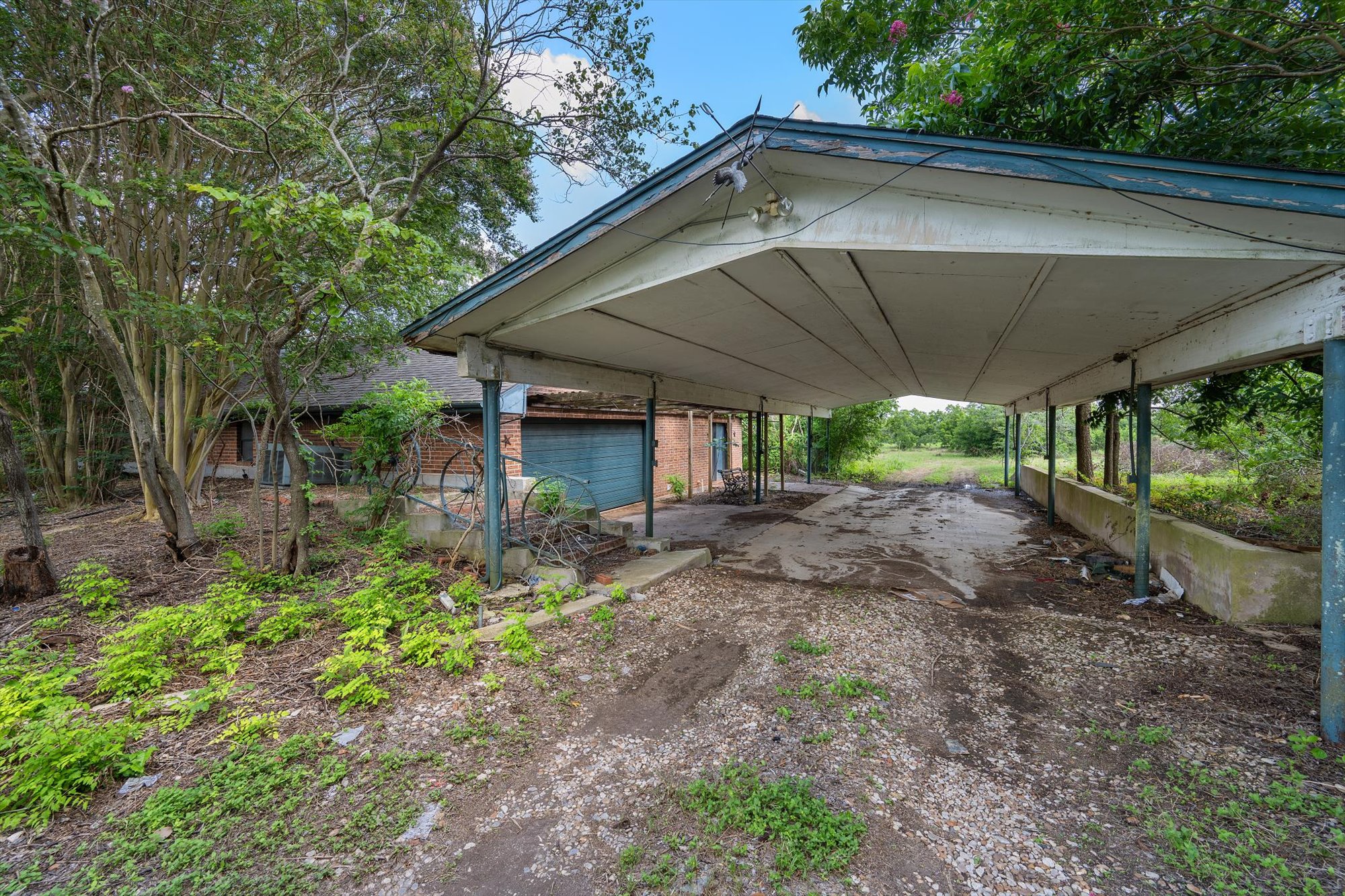 14201 Lund - Carlson Road Coupland, TX 78615 - Photo 21 of 40 A spacious carport offers convenient, sheltered parking adjacent to the home.