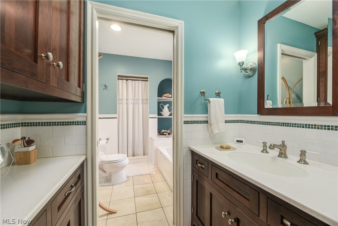 3349 Elsmere Road Cleveland, OH 44120 - Photo 27 of 50 Bathroom with tile walls, toilet, tile floors, tasteful backsplash, and vanity