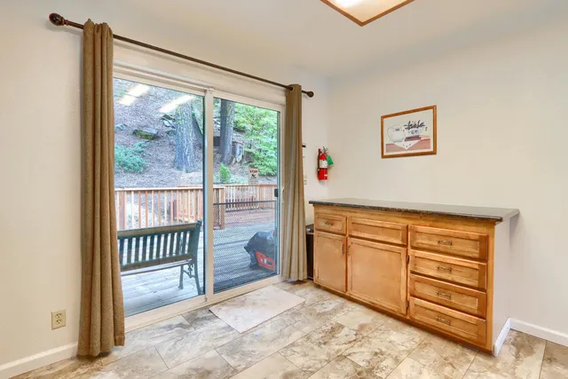 a view of a hallway with sliding door and wooden floor