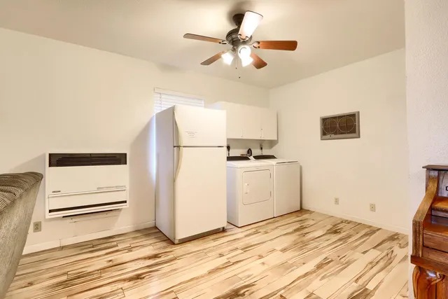 a view of kitchen with wooden floor and electronic appliances