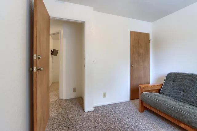 a living room with furniture and a walk in closet