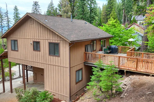 a view of a small house with wooden fence and plants
