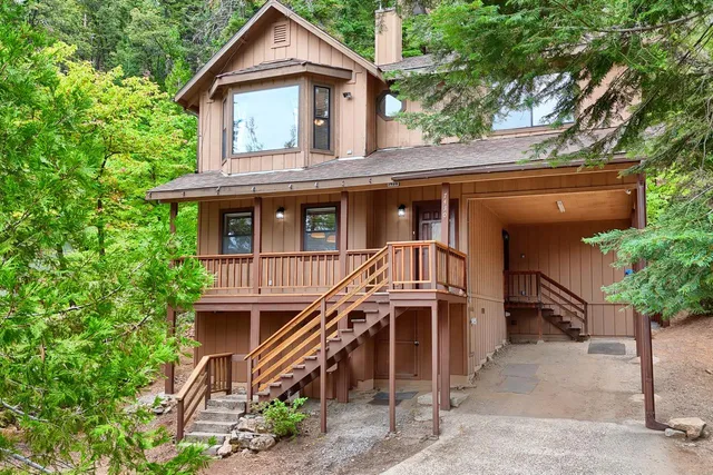 a house that has a tree in front of the house