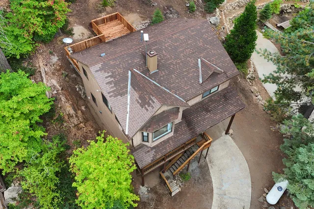 an aerial view of a house with a yard