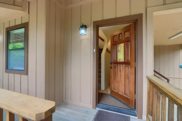 a view of a hallway with wooden floor and entryway